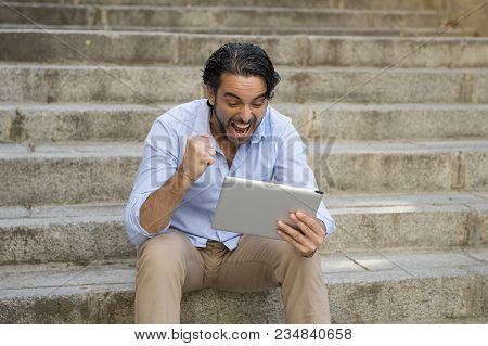 Young Happy Attractive Hispanic Man In Casual Trendy Clothes Smiling Cheerful Using Internet With Di