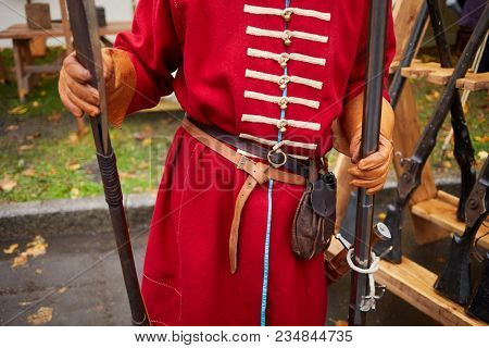 Man dressed as russian strelets (shooter) with musket and poleaxe.