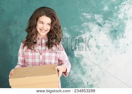 Beautiful Young Girl With Relocation Box. Happy Smile