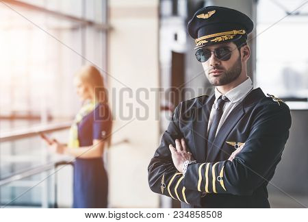 Pilot And Flight Attendant In Airport