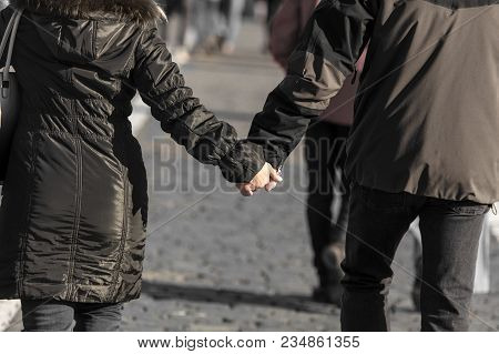 Hands Of A Man And A Woman In A Park In Winter