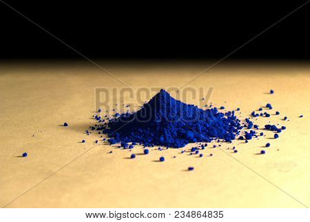 An Isolated Stack Of Blue Powder Pigment Over A Vanilla Paper