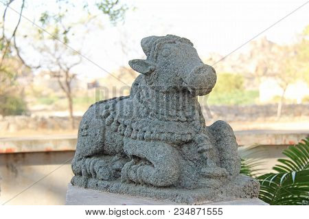 Nandi Stone Lies In The Open-air Museum In Hampi, India. Stone Sculpture. Sacred Cow Stone Sculpture