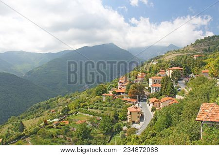 The City Of Trior, Italy. View Of The Houses On The Mountain And The Green Forest. Alpine Mountains.
