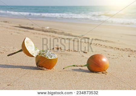 Two Orange Open Passion Fruit With Seeds. Passion Fruit Closeup On The Beach, On The Sand And On The