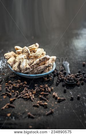 Close Up Of Ayurvedic Herb Or Folk Medicine Dried Ginger Or Zingiber Officinale With Black Pepper Co