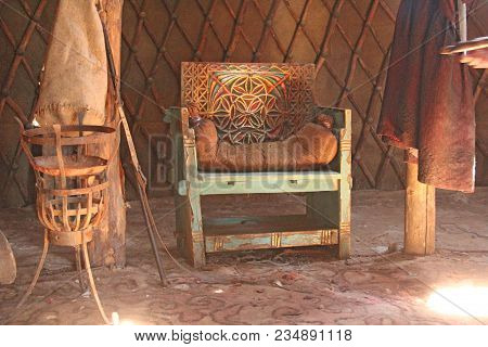An Antique Or Ancient Wooden Armchair With Leather Trim In The Sun. Beautiful Wooden Interior. Sarai