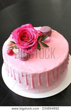 Tasty Pink Homemade Cake Decorated By Rose And Macarons.