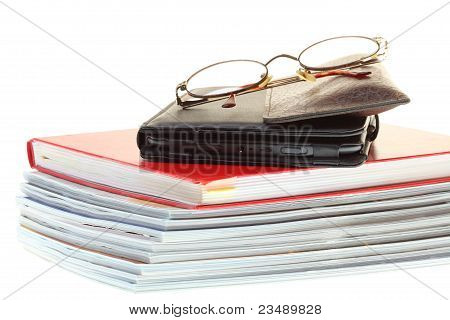 glasses eBook reader pile of books
