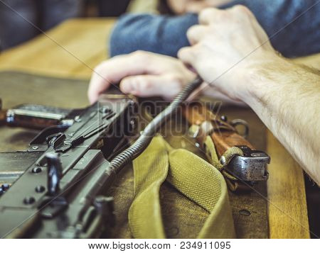 Man Disassemble Rifle Close Up On The Table