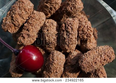 Top View Of Chocolate Truffles With A Fresh Cherry