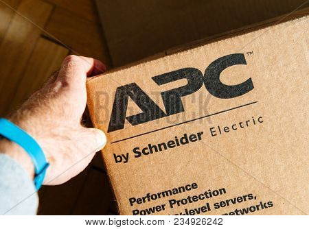 Paris, France - Mar 29, 2018: Man Holding Hand Near The Logo Of Apc Smart-ups C Enterprise-level Uni