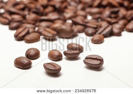 Spilled Roasted Coffee Beans On White Background, Close Up