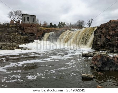 The Big Sioux River Flows Over Rocks In Sioux Falls South Dakota With Views Of Wildlife, Ruins, Park