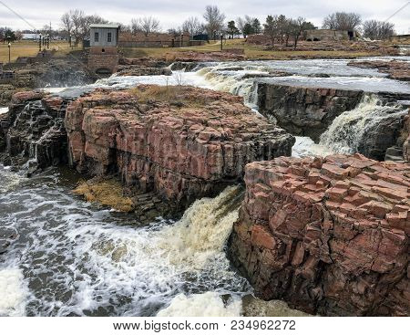 The Big Sioux River Flows Over Rocks In Sioux Falls South Dakota With Views Of Wildlife, Ruins, Park
