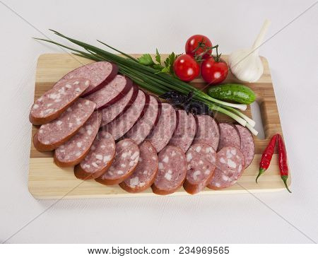 Still Life With Sliced Smoked Sausage Greens And Tomatoes On A White Background. Can Be Used For Ban