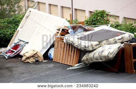 Tenants Who Were Evicted Left Their Broken Furniture On The Pavement Outdoors.