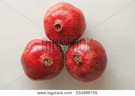 Big Ripe Red Granets Or Garnets. Fruits Of Red Ripe Pomegranate On The White Background. Vegetarian 