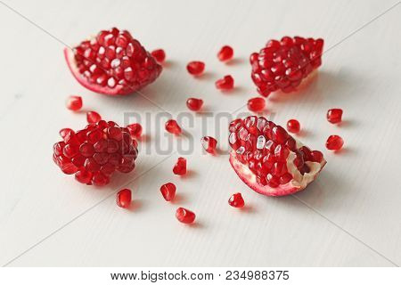 Big Ripe Red Granets Or Garnets. Fruits Of Red Ripe Pomegranate On The White Background. Vegetarian 