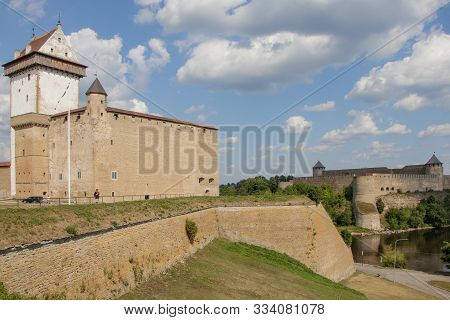 View Of The Estonian Narva Castle, The Russian Ivangorod Fortress And The Border River Narva.