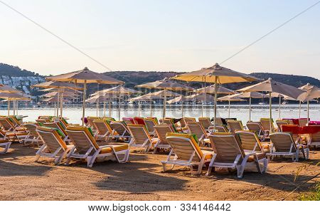 Beautiful Beach On The Shores Of The Calm Blue Bay Of The Aegean Sea In The Early Morning. Beach Vac