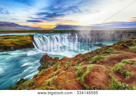 Fantastic Sunset Scene Of Powerful Godafoss Waterfall. Dramatic Sky Over Godafoss. Location: Bardard