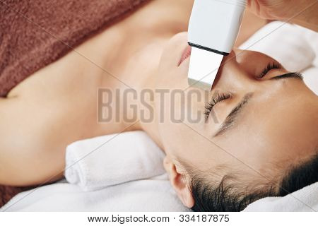 Close-up Image Of Young Woman Getting Ultrasound Skin Cleaning In Beauty Salon