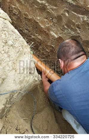 The Contractor Installs A Sewer In A Ditch And Leads The Pipe To The Sump.