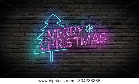 Merry Christmas Shiny Neon Lamps Sign Glow On Black Brick Wall. Colorful Sign Board With Text Merry 