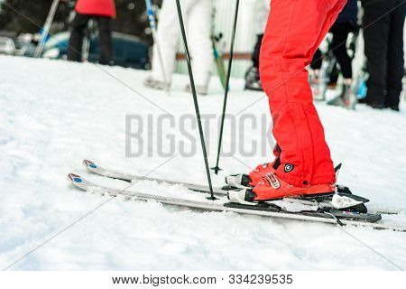 Yablunytsia, Ukraine February 2, 2019: Woman In Red Pants And Red Boots Goes Skiing, Tourists Of Ukr