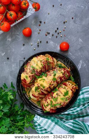 Hasselback Potato Stuffed With Salami, Cheese, Ketchup, Garlic And Herbs. Baked Whole Potatoes Is Sl