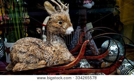 Beautiful Brown Christmas Deer Toy. Deer Sitting On The Sleigh Of Santa Clus. New Years Toys On The 