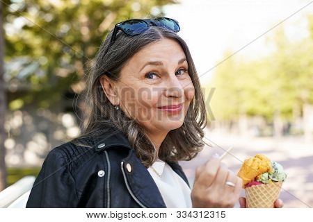 Cheerful Beautiful Mature European Female In Her Fifty Enjoying The Nice Summer Weather Outdoors, Si