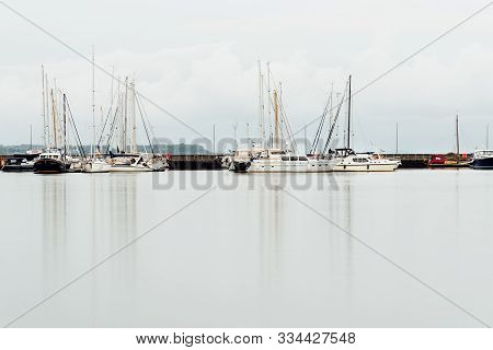 Stralsund, Germany - August 1, 2019: View Of The Harbour With Sailboats Moored. Long Exposure View W