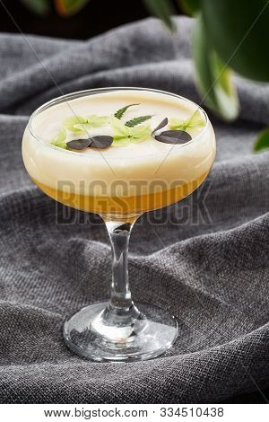 Homemade Pisco Sour Cocktail. Whiskey Sour In Coupe Glass With Ice On Gray Background. Overhead View