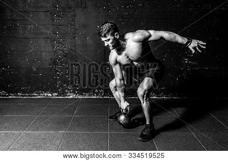 Kettlebell Swing, Young Strong Sweaty Focused Fit Muscular Man With Big Muscles Holding Heavy Kettle