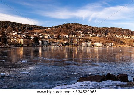 Serraia Lake (lago Della Serraia) Frozen In Winter And The Small Town Of Baselga Di Pine. Trento Pro
