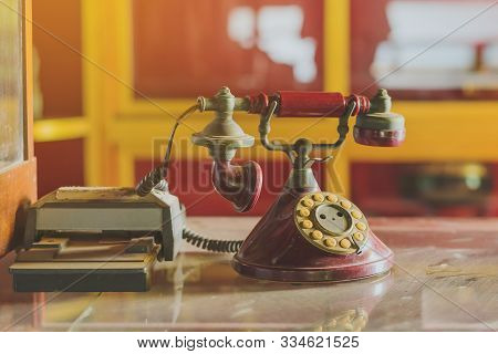 A Red Telehones With Rotary Dial With Dust And Scratches And Credit Card Machine In Ancient Times Pl