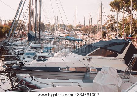 Yacht Club. Yachts Moored In The Port Against The Backdrop Of The Setting Sun.