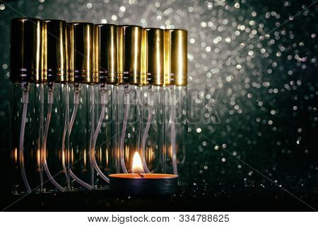 Transparent Atomizer Sprayers For Perfumes On A Dark Sparkling Background. Perfumes And Fragrances. 