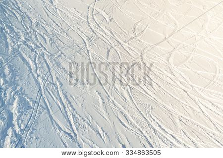 Snowy Abstract Off-piste Skiing Backround With Ski And Snowboard Trails And Tracks On New Virgin Pow