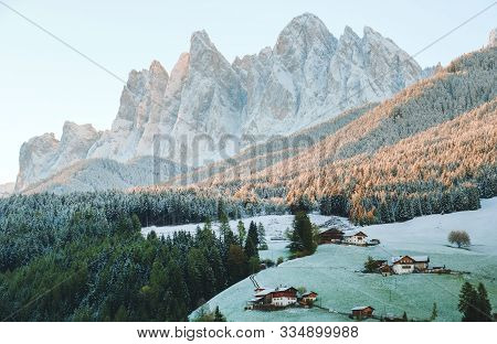 The Small Village Val Di Funes Covered In Snow, With Dolomites Mountains, South Tyrol, Italy.