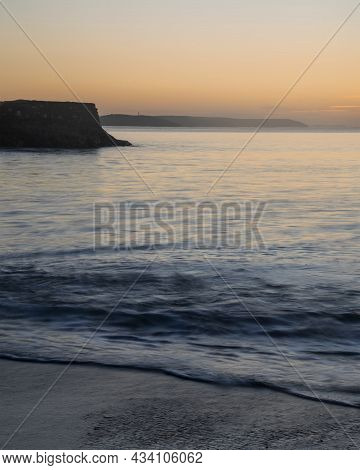 Beautiful Vibrant Late Summer Sunrise Over Pentewan Sands On English Cornwall Coast With Long Exposu