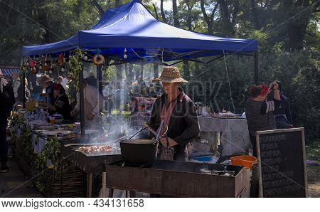 Korosten' Ukraine - September 04 2021: Festival Of Potato Pancakes In The City Park. Vendors Prepare