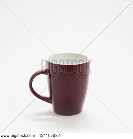 Empty Plain And Simple Brown Colored Coffee Cup In A White Background