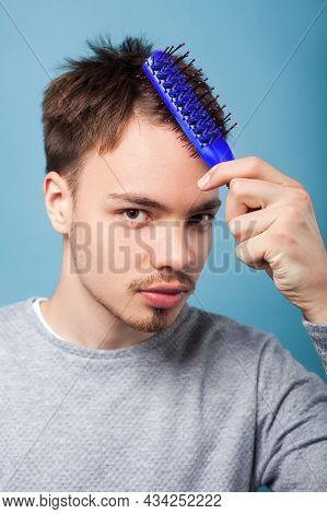 Healthy Hair. Portrait Of Brunette Man With Small Beard And Mustache In Casual Sweater Combing His H
