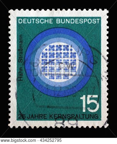 ZAGREB, CROATIA - JUNE 27, 2014: Stamp printed in Germany showing 25th anniv. of publication of Hahn-Strassmann treatise on splitting the nucleus of the atom, circa 1964