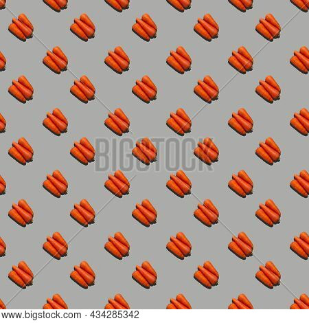 Seamless Pattern From Fresh Juicy Carrots On A Uniform Colored Background.