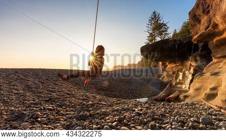 Adventurous White Caucasian Woman On A Swing At Sandcut Beach On The West Coast Of Pacific Ocean. Su