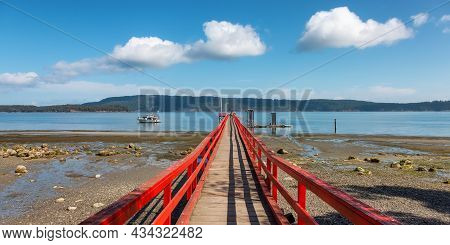 Wooden Pier By The Pacific Ocean West Coast. Sunny Summer Day. Fernwood Point Beach, Salt Spring Isl